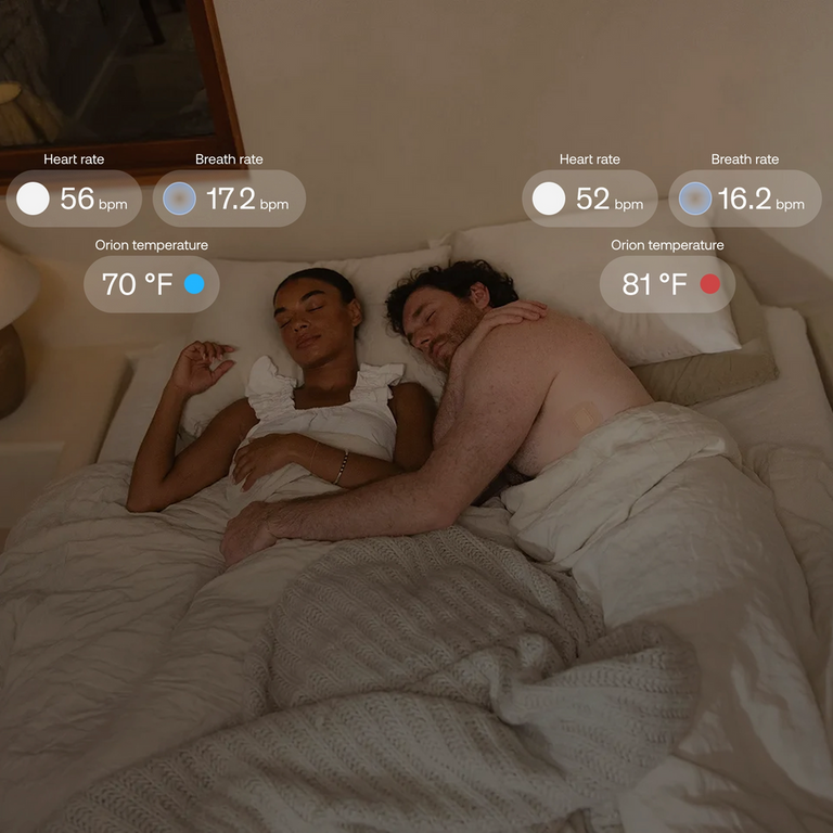 Man and woman in bed with sleep metrics from Orion Sleep System