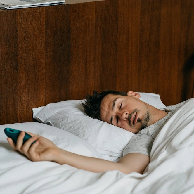 Man using Moonbird breathing coach while in bed