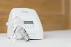 A cpap machine on a white bed