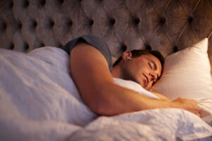 Man sleeping with ear buds in