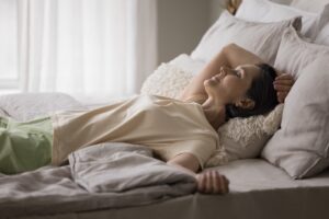 A woman sleeps cooler with a cross breeze, cooler sleep wear and a cooling mattress